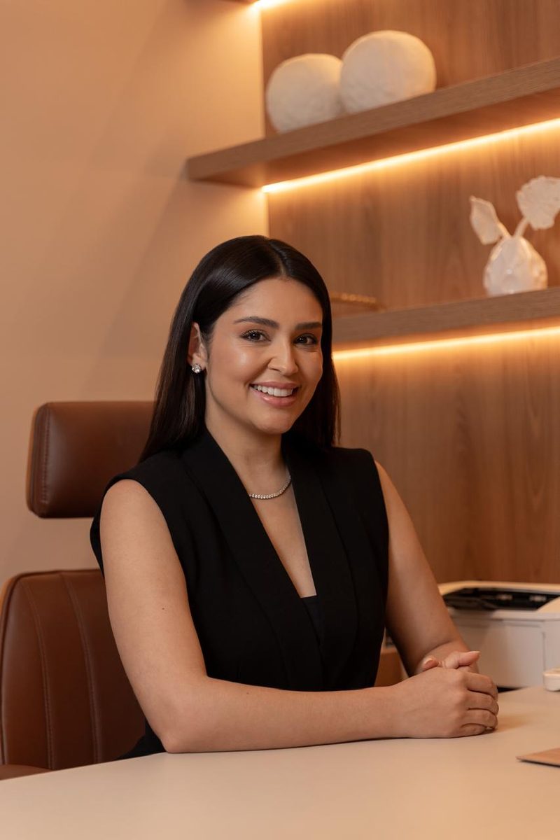 Dra. Harymy Barros sorrindo em seu consultório